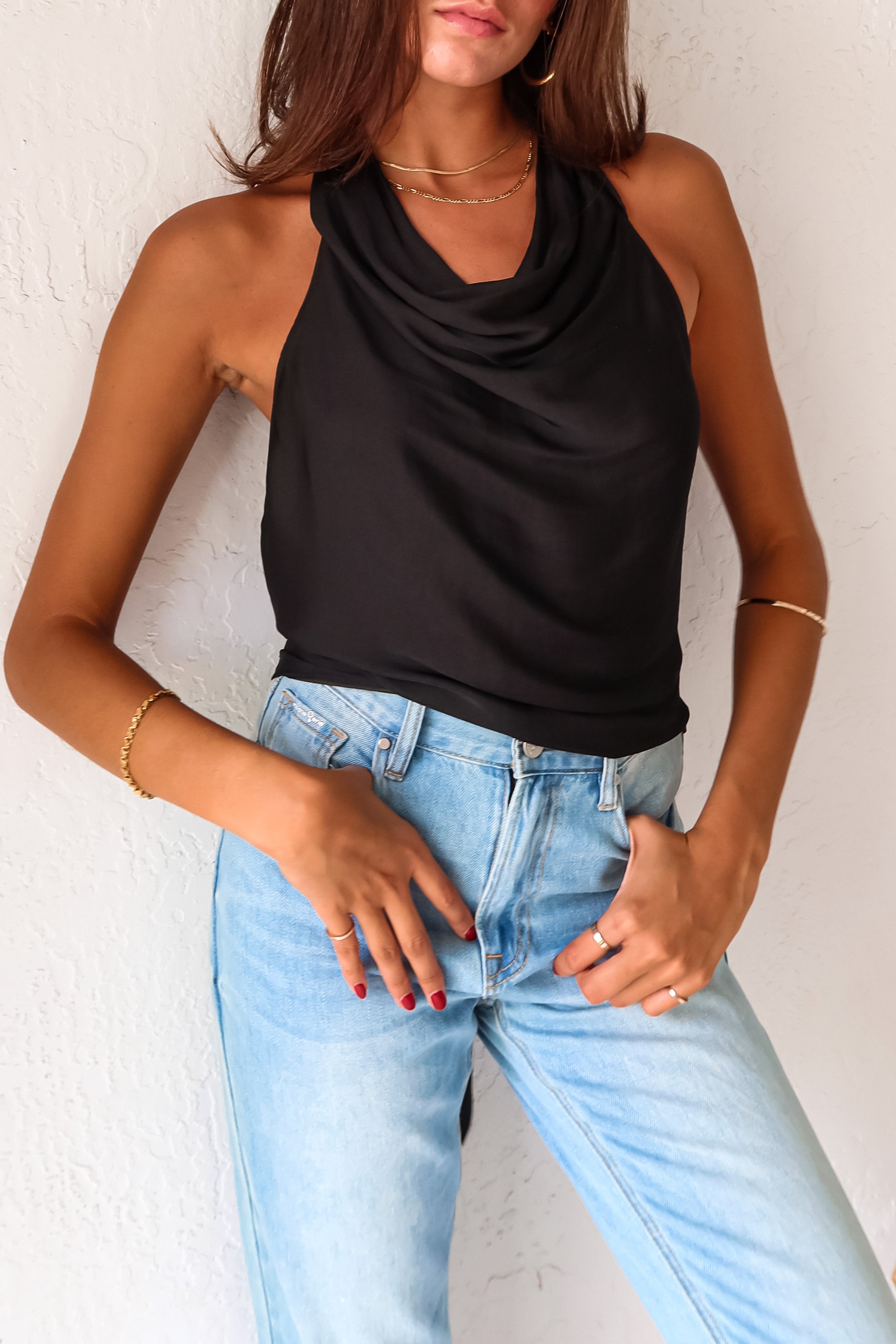 TGIF Satin Wrap Top in sleek black. The back tie around the neck and waist allows for a customizable fit, while the cowl neck adds a touch of elegance.