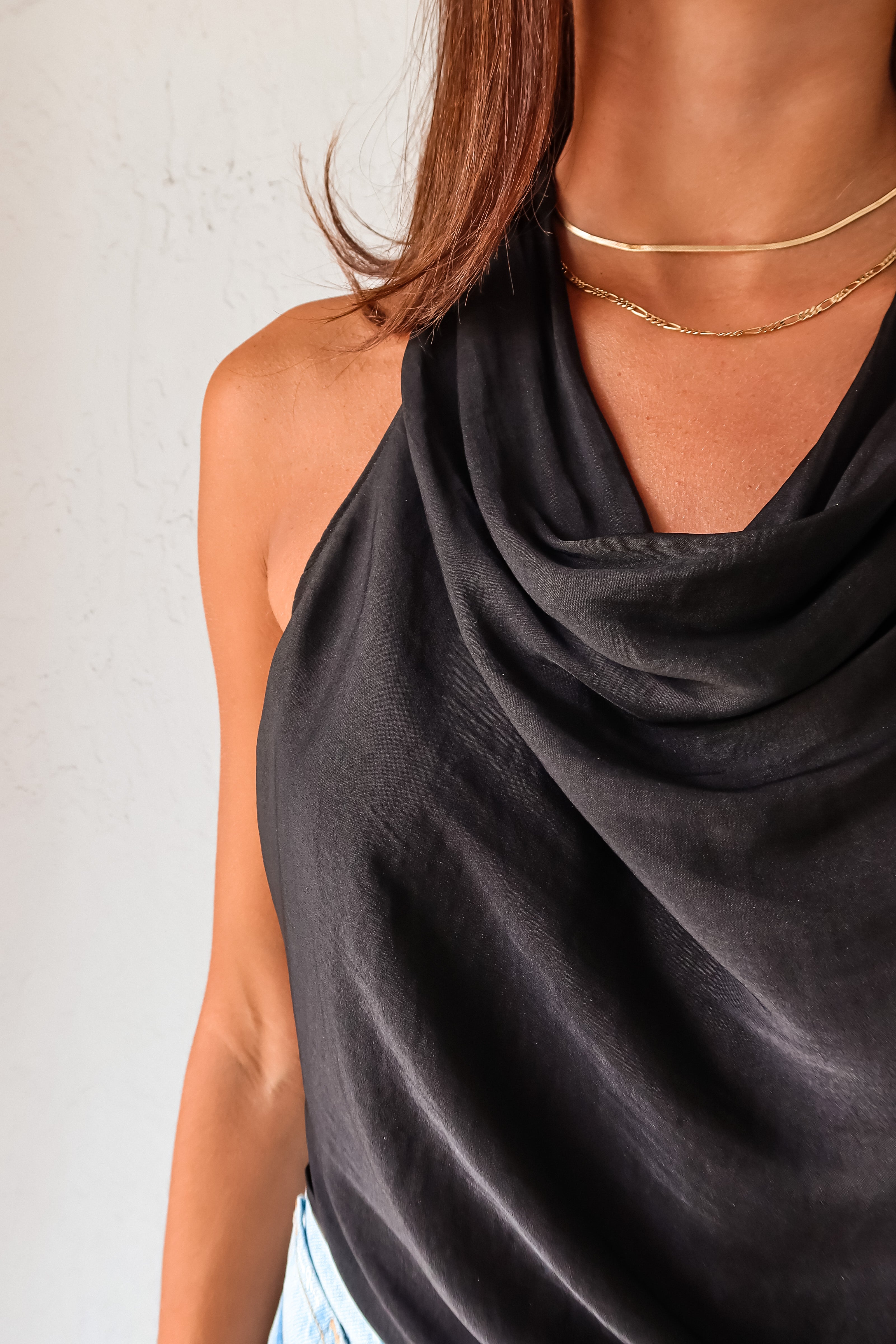 TGIF Satin Wrap Top in sleek black. The back tie around the neck and waist allows for a customizable fit, while the cowl neck adds a touch of elegance.