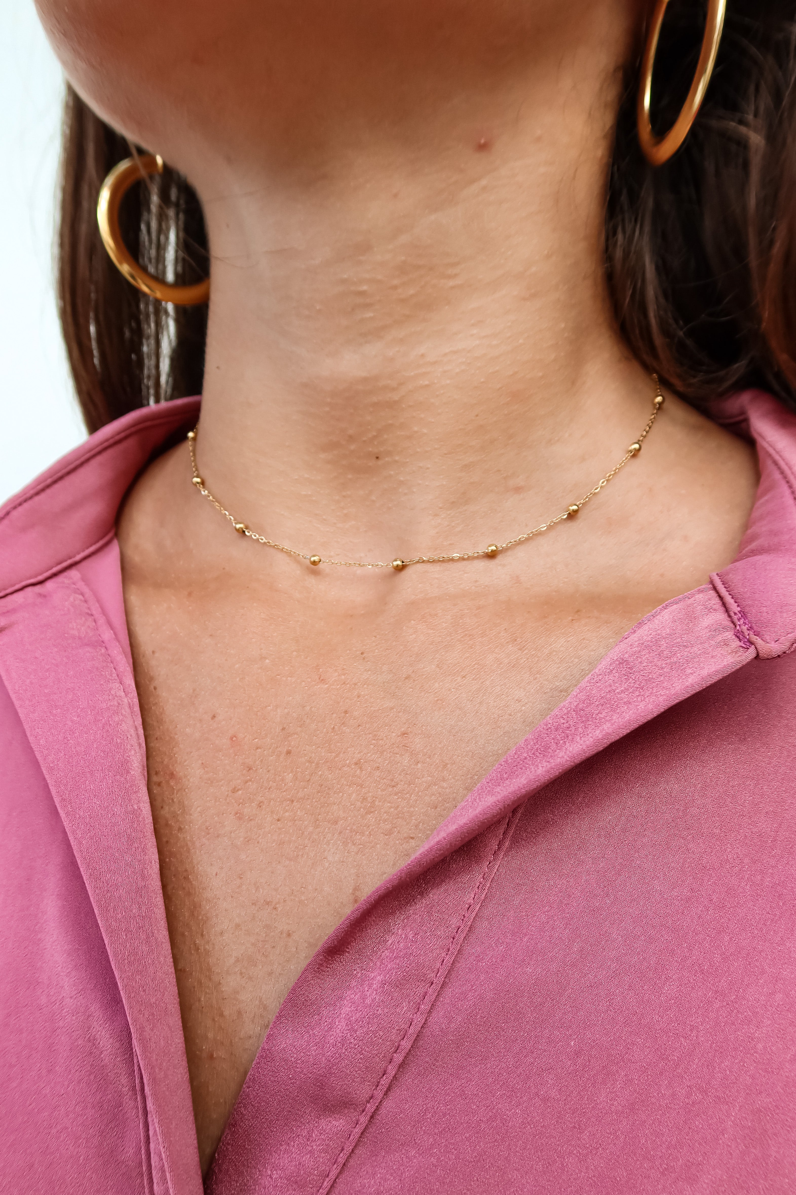 Add a touch of glamour to your outfit with our SS CORE CHOKER. Made from stainless steel, this gold beaded choker won't tarnish or change color. The bead neckline chain and lobster claw closure ensure a perfect fit. At 8 inches long, it's a must-have accessory!