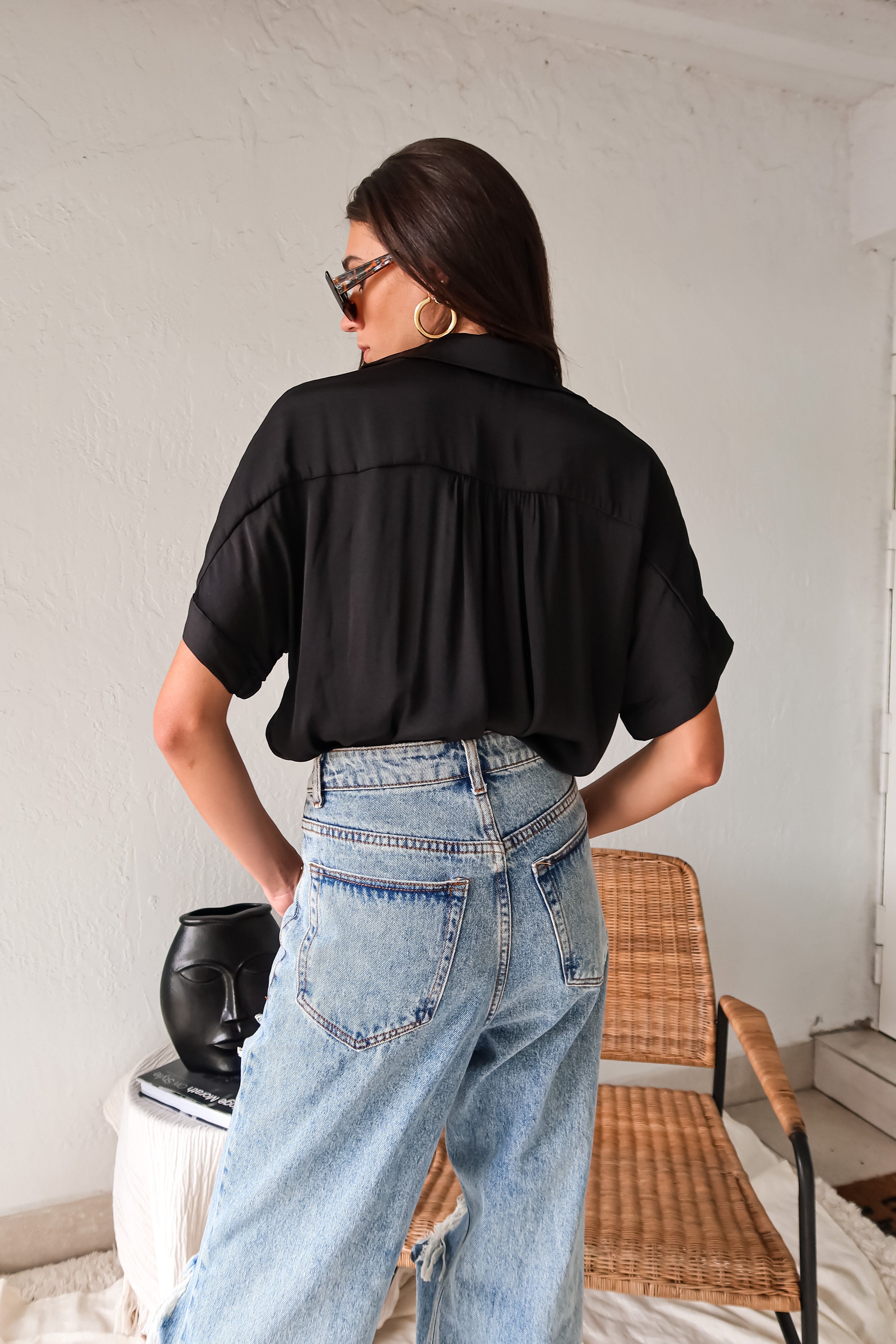 DOWNTOWN BLOUSE in classic black is a best seller for a reason. With a v-neck collared design and lightweight satin feel, this top is effortlessly chic. The cuffed sleeve adds a touch of sophistication