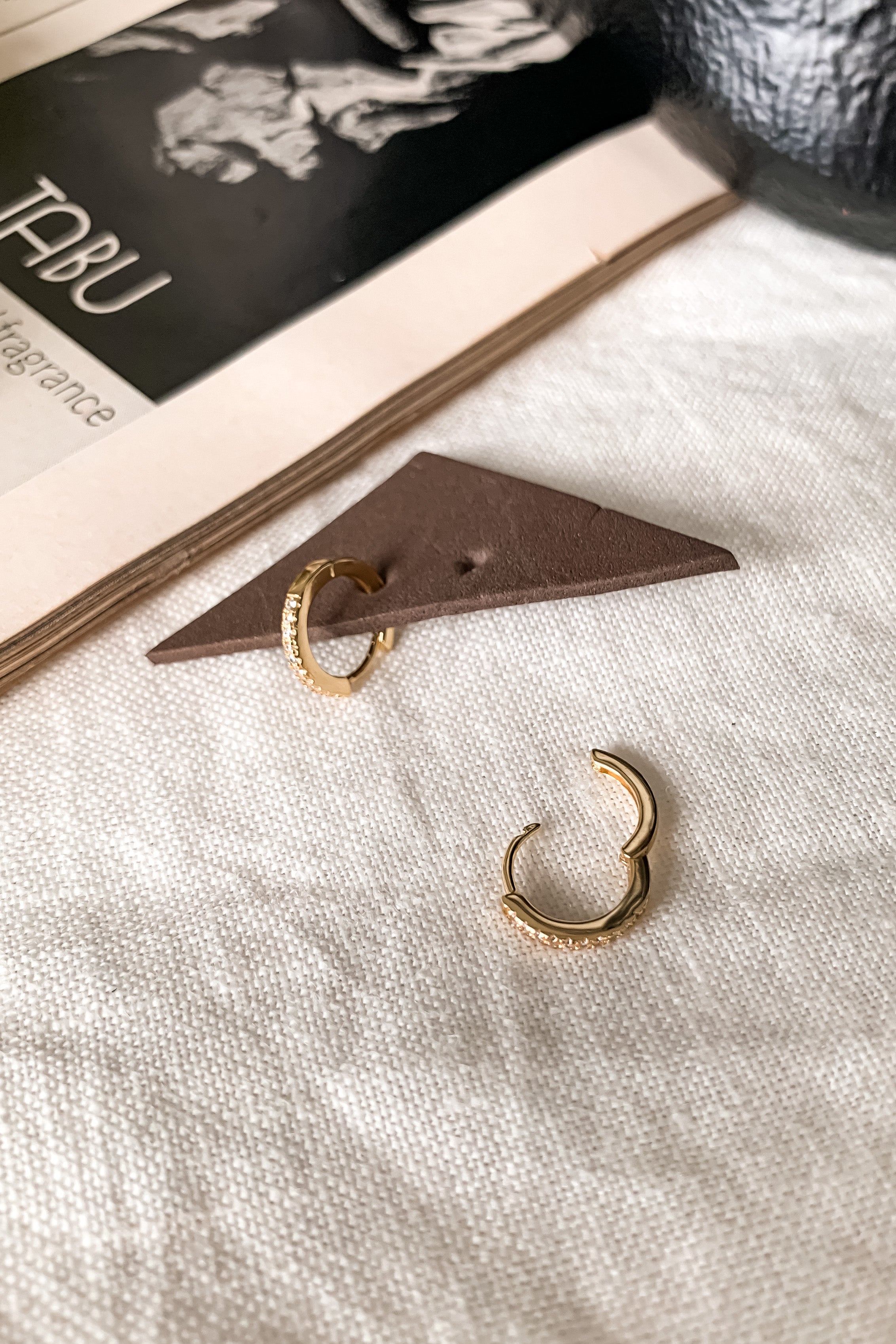 Add a touch of glam with these pave huggie earrings. Gold plated over sterling silver, these hoops offer a secure wire closure and 2 cm length. Perfect for everyday wear (and showing off!).