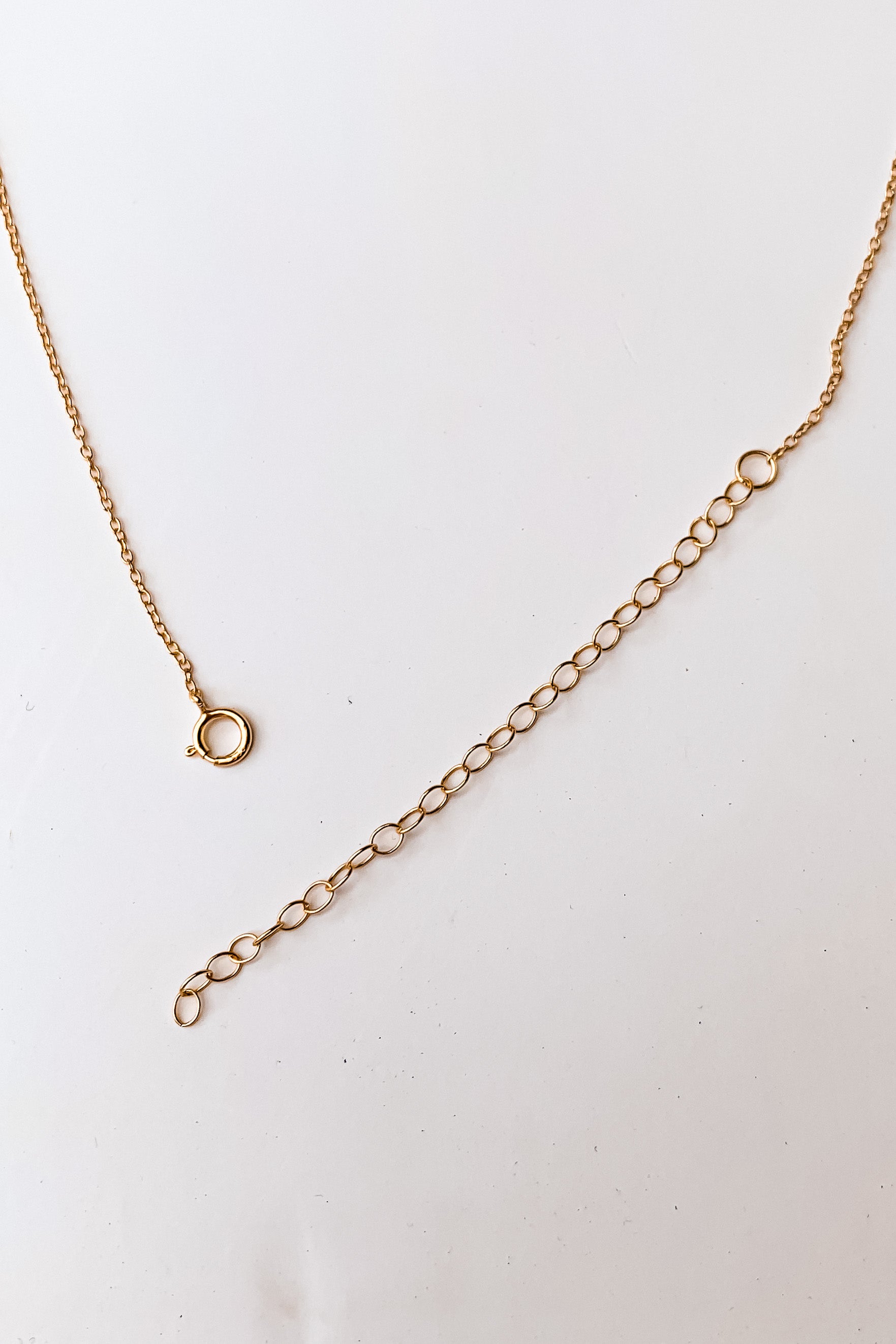 best selling Moon + Stars Necklace. This gold plated choker features a delicate moon and star charm and a secure spring ring clasp closure. With an adjustable 13 inch chain and 2 inch extender, it's crafted with high quality 925 sterling silver