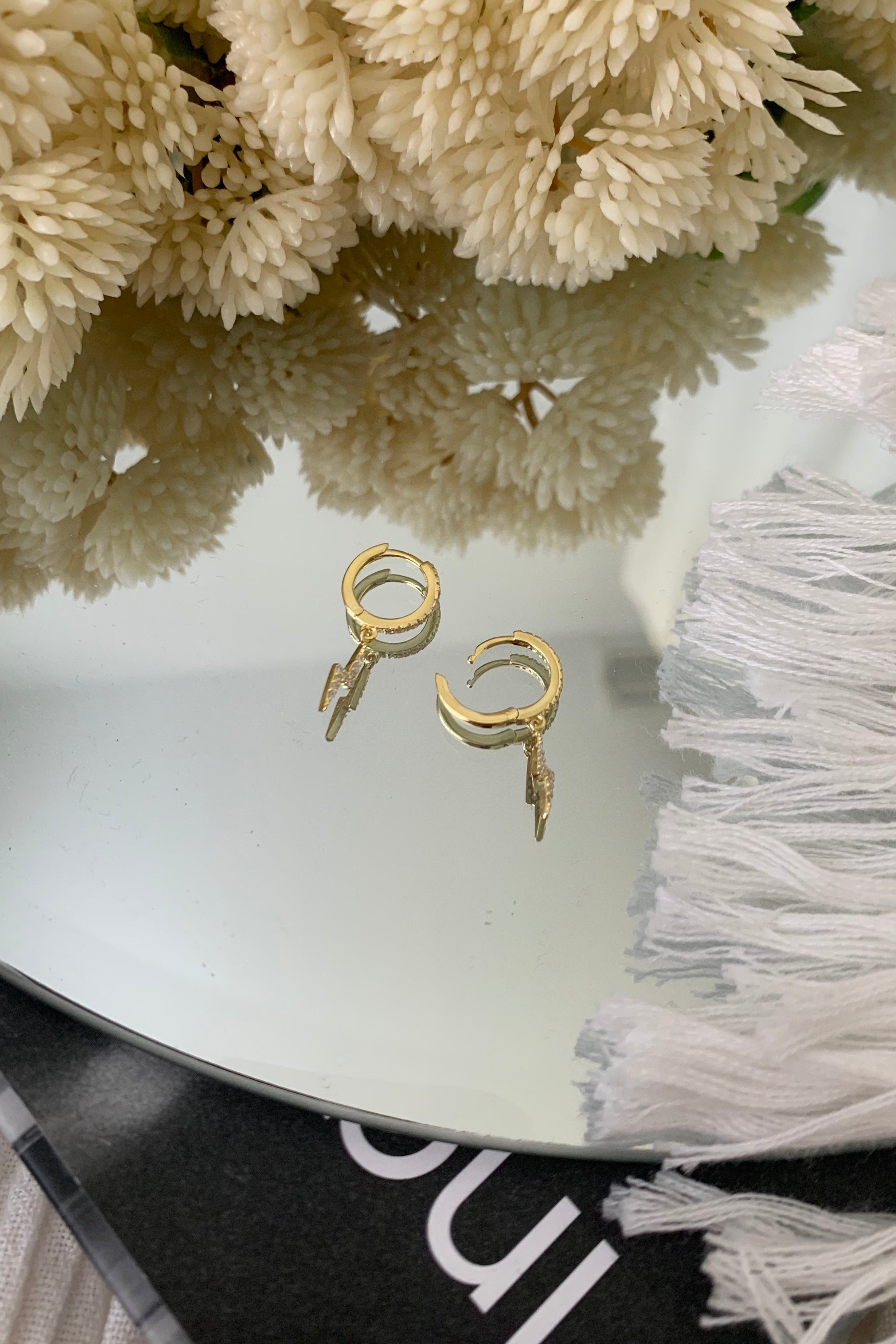 Go bold with our BOLT EARRING! This unique, gold plated design adds a touch of whimsy to any outfit. Made with sterling silver and a hoop wire closure, measuring 2 1/2 cm in length. It's time to amp up your accessory game!