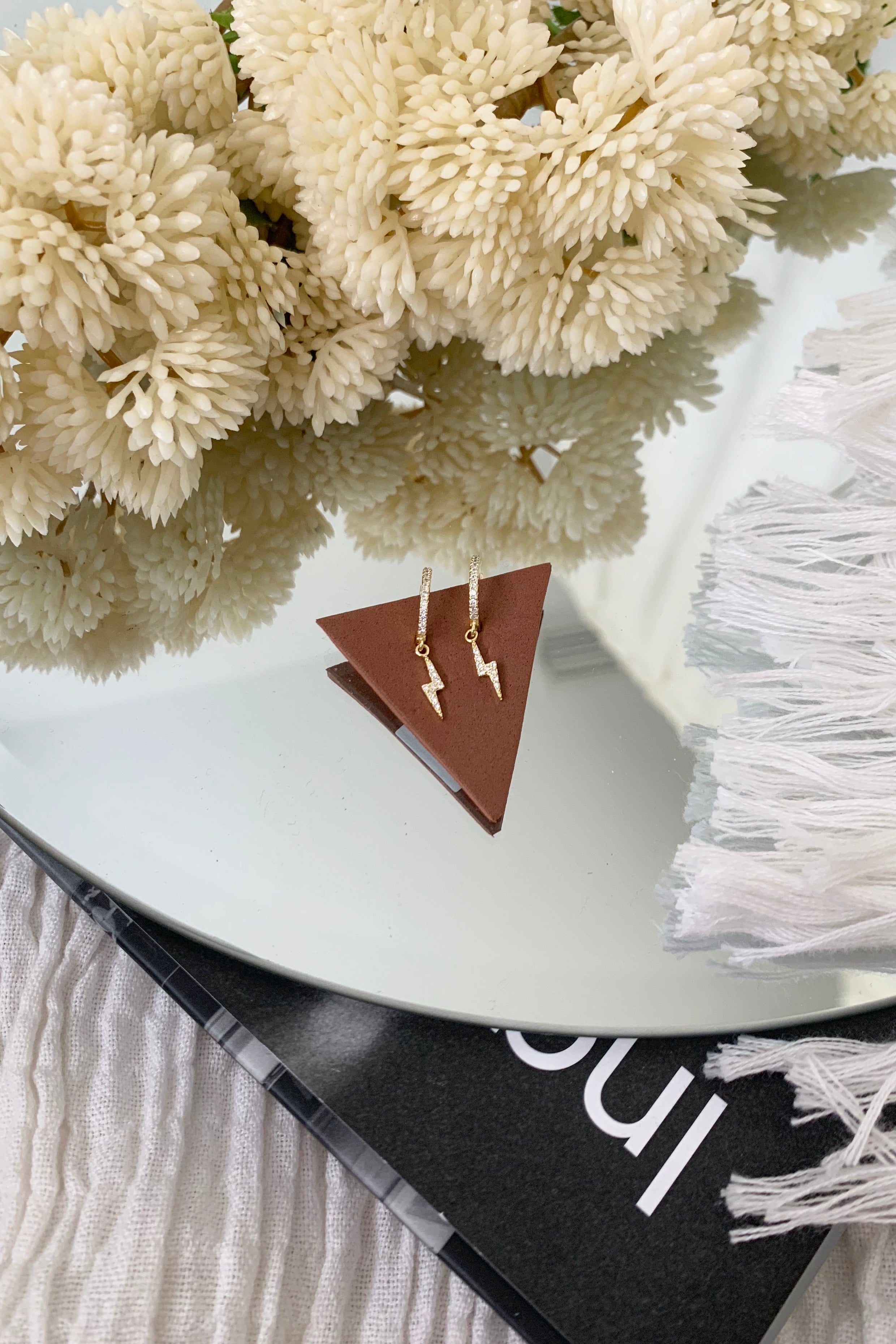 Go bold with our BOLT EARRING! This unique, gold plated design adds a touch of whimsy to any outfit. Made with sterling silver and a hoop wire closure, measuring 2 1/2 cm in length. It's time to amp up your accessory game!