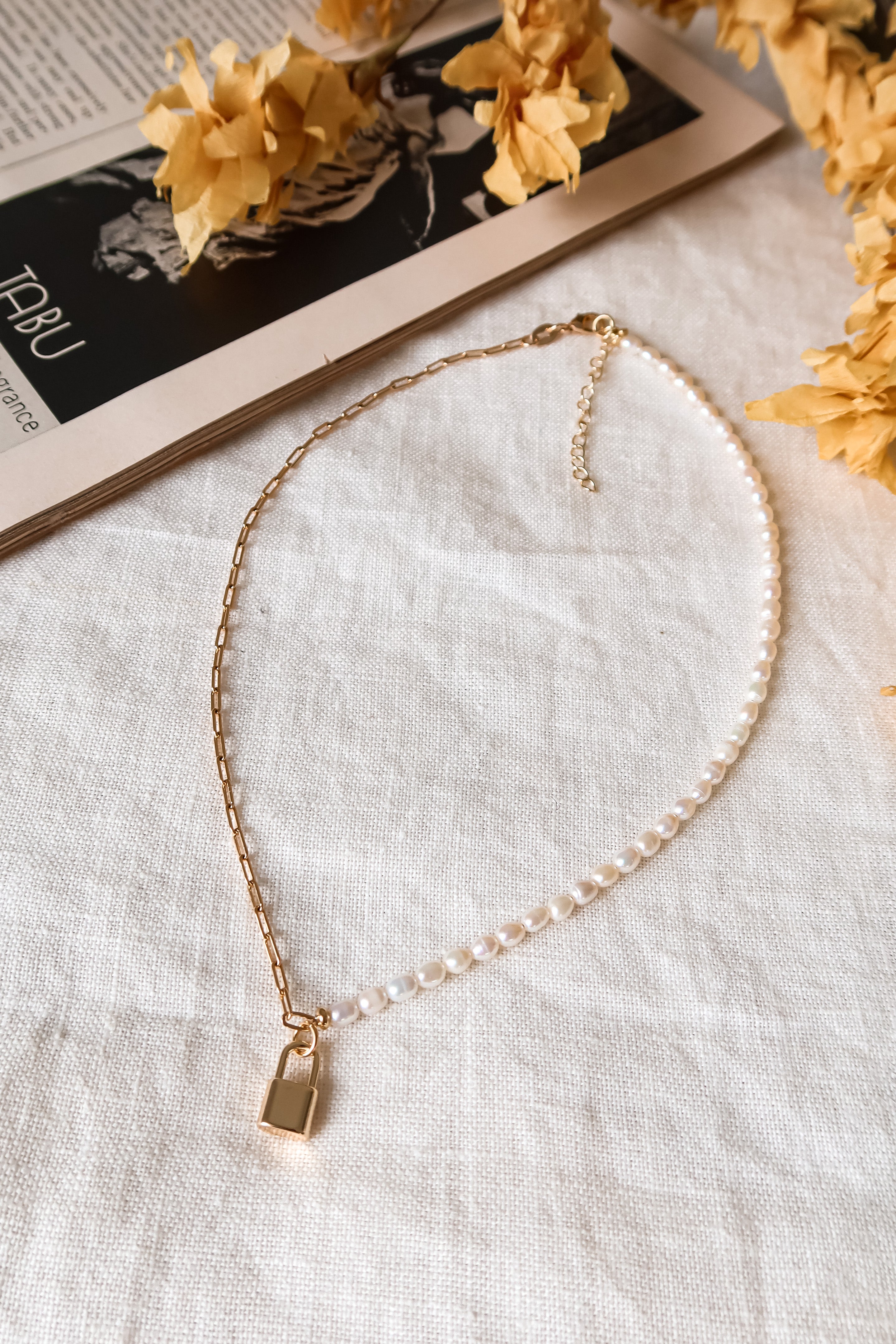 Upgrade your jewelry game with our PEARL AND CHAIN NECKLACE. Crafted with real freshwater pearls and a gold plated chain, this necklace adds an elegant touch to any outfit. The lobster clasp closure ensures a secure fit. Approx. 15 inches in length. Treat yourself to some luxury without breaking the bank!